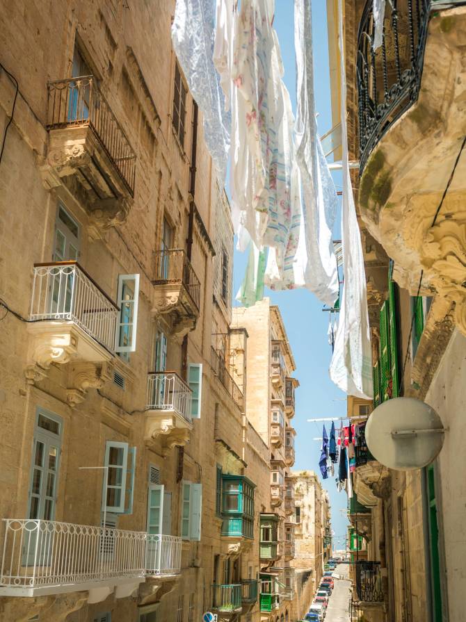 street with traditional balconies in historical center of Valletta in Malta